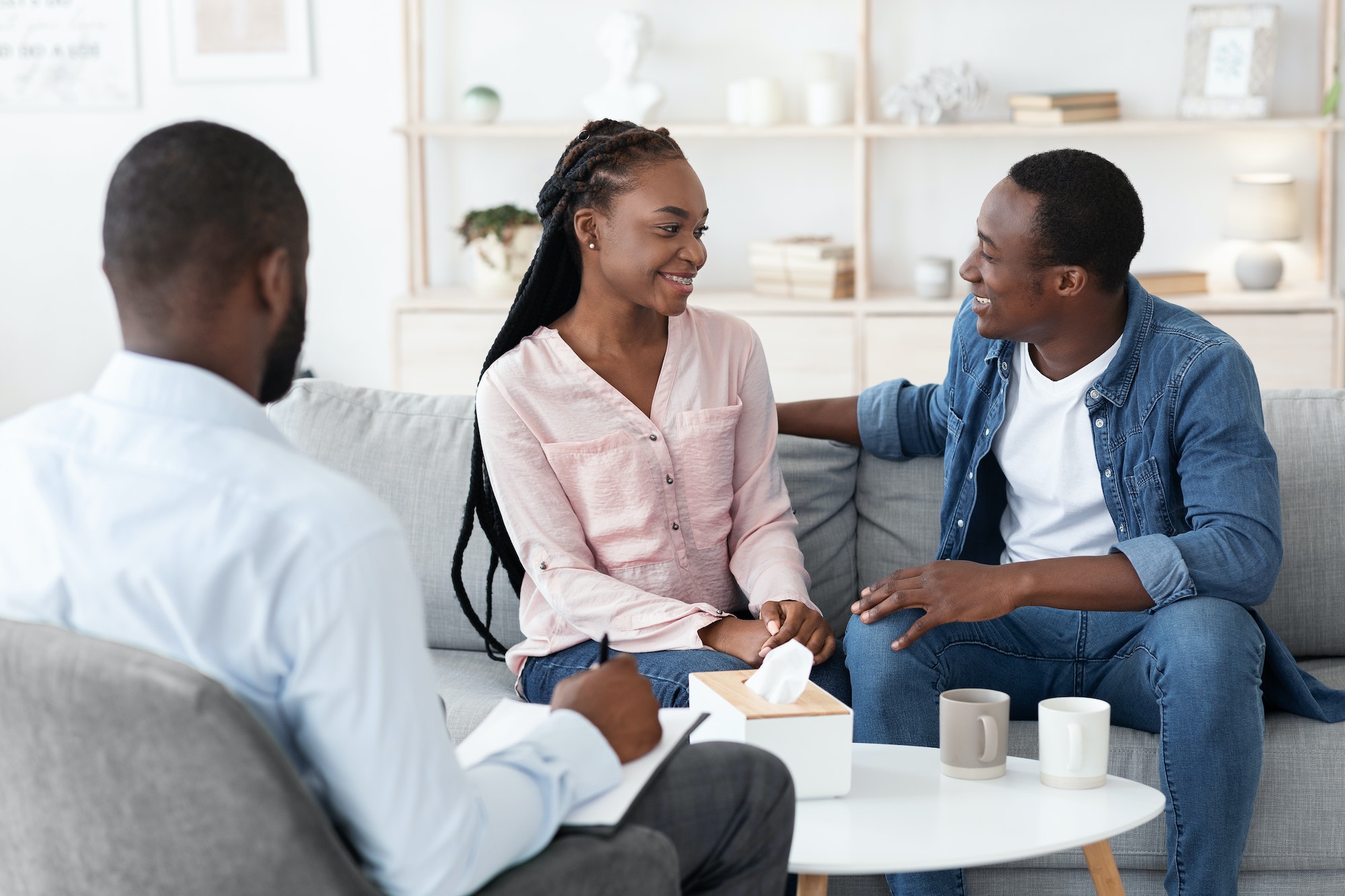 Marriage Consulting. Smiling Black Couple Sitting At Psychologist Office After Happy Reconciliation
